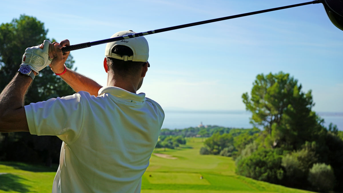 A man swinging a golf club on a golf course